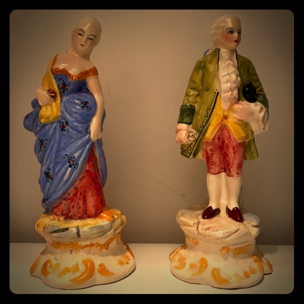 Two 7 1/2 inch porcelain figurines.